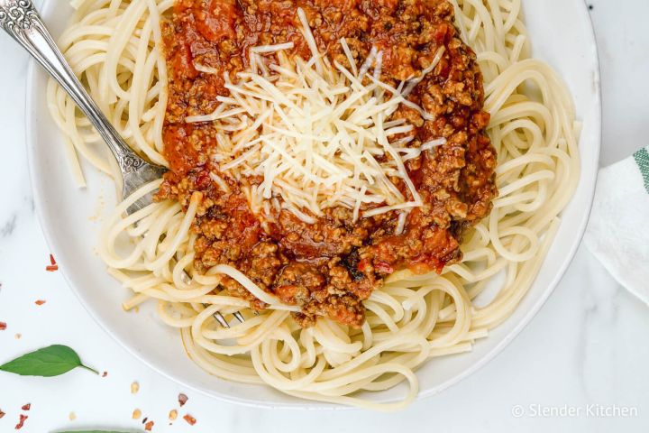 Spaghetti arrabiata with spicy tomato sauce served over a plate of pasta.