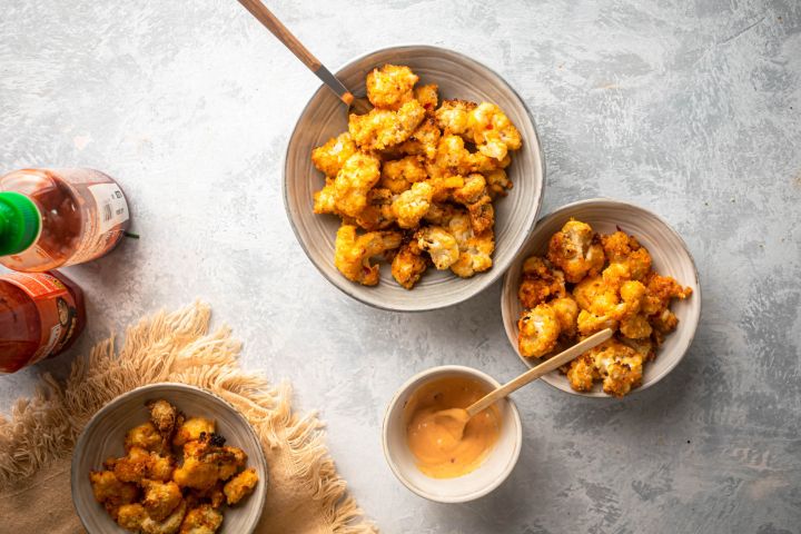 Bang bang cauliflower baked with breadcrumbs and tossed in a sweet and spicy orange sauce.