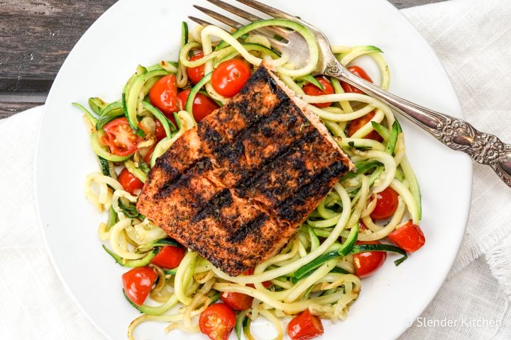 Blackened Salmon over a bed of zucchini noodles with cherry tomatoes.