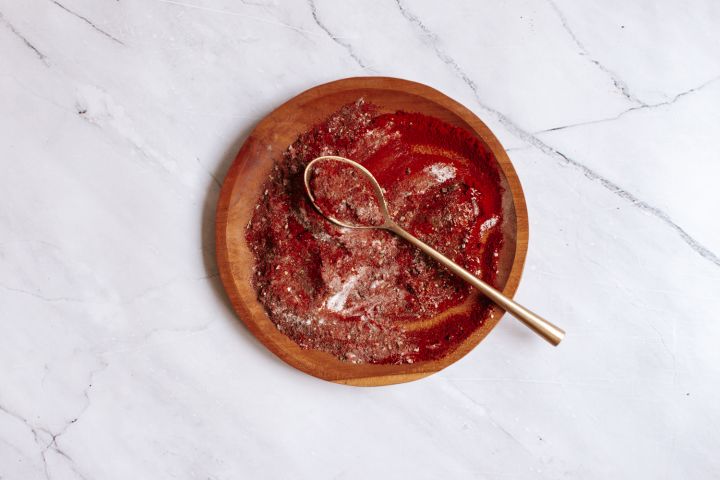 Blackening seasoning on a wooden plate with paprika, garlic powder, oregano, and more.