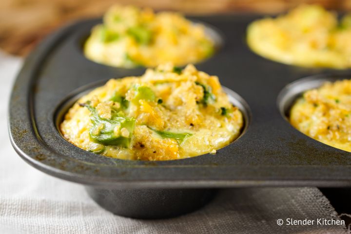 Broccoli cheddar quinoa egg muffins with cooked broccoli, cooked quinoa, and eggs cooked in a muffin tin. 