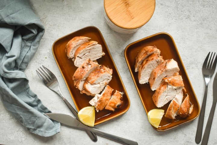 Browns sugar garlic chicken breasts sliced on a plate with a crispy brown sugar topping.