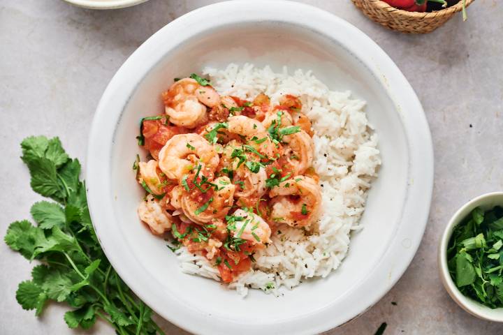 Camarones rancheros with tomatoes, serrano peppers, garlic, and onion sauce served over white rice with fresh cilantro.