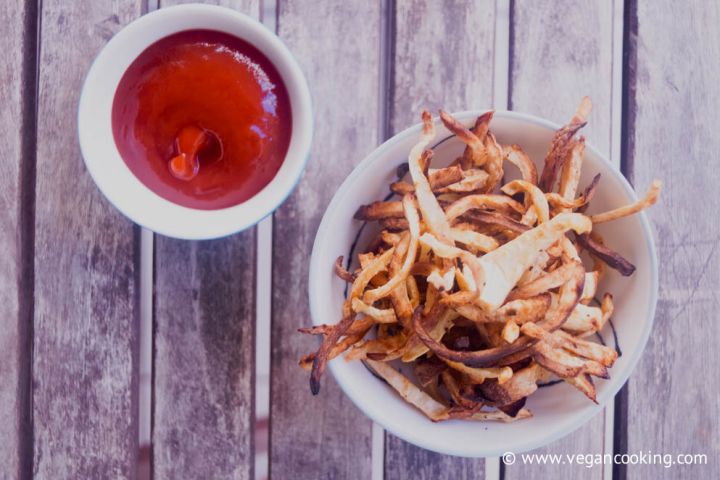 Celeriac fries baked until crisp and golden brown served in a bowl.