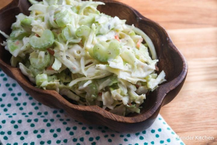 Ranch coleslaw with shredded cabbage, chopped celery, parsley, and ranch dressing in a bowl.