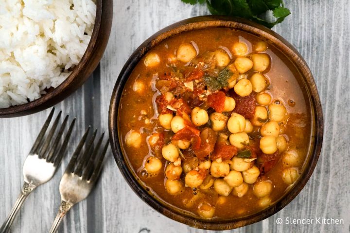 Easy chana masala recipe with a bowl of basmati rice and a fork.