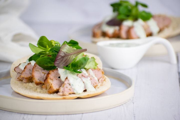 Chicken gyros with tzatziki on pita bread with lettuce.
