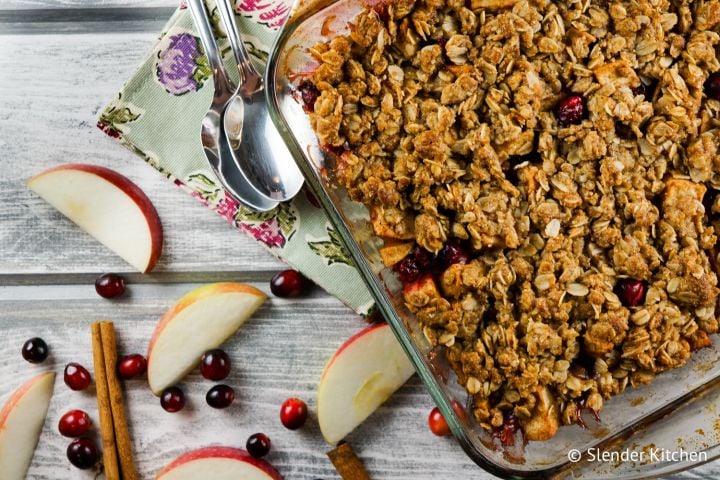 Cranberry apple crisp with a oatmeal crumble topping in a baking dish. 