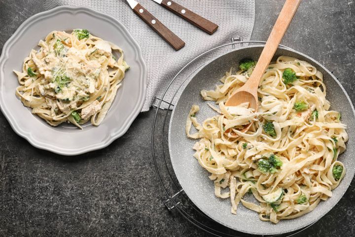 Chicken and broccoli pasta in a bowl with a creamy Parmesan sauce.