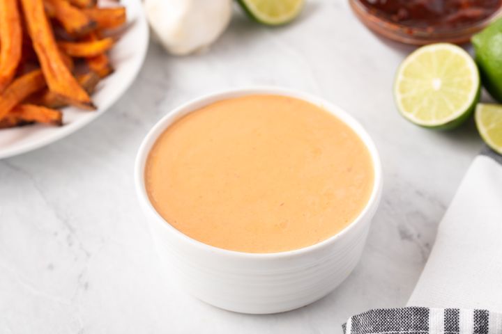 Creamy chipotle sauce with Greek yogurt, mayonnaise, and chipotle peppers in a small white bowl with fries on the side.