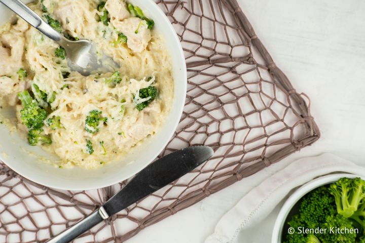 Creamy Parmesan Spaghetti Squash with chicken breast and broccoli in a bowl.