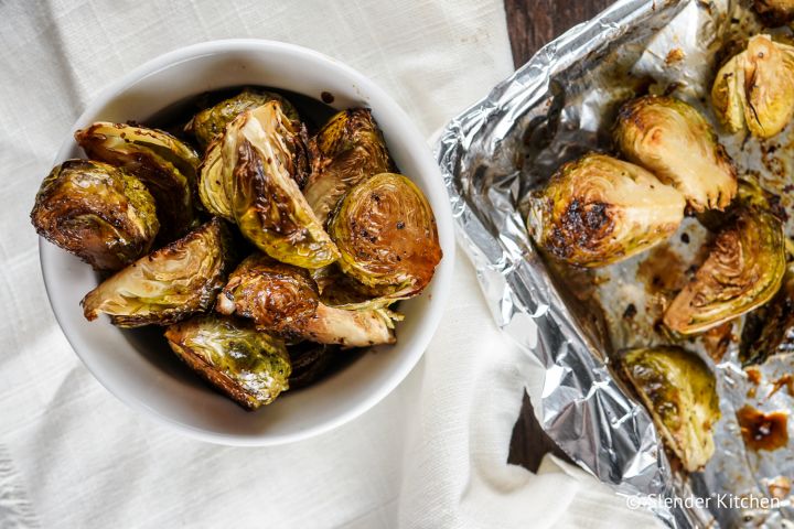 Crispy balsamic brussels sprouts with olive oil, garlic, salt, and pepper in a bowl. 