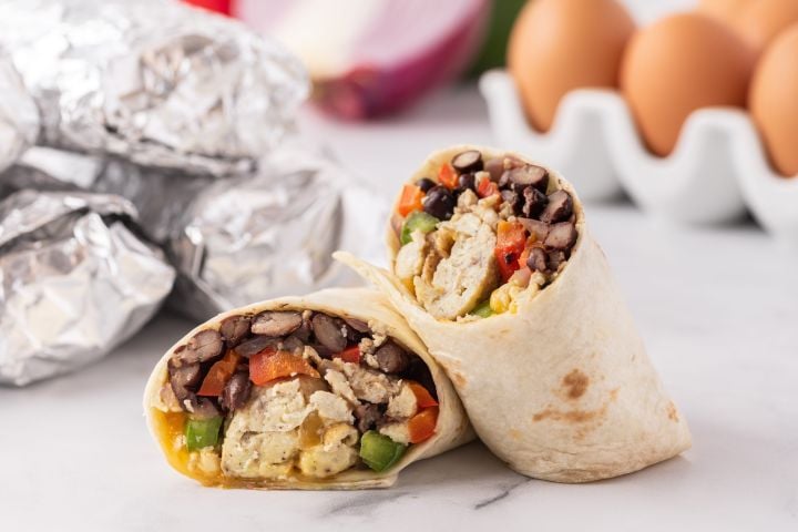 Freeezer breakfast burritos with eggs, peppers, black beans, and cheese wrapped in a tortilla.