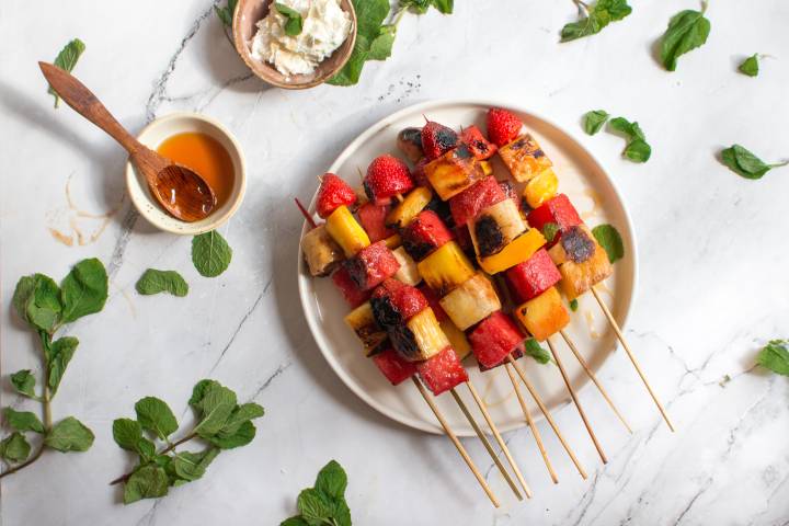 Grilled fruit skewers with watermelon, strawberry, pineapple, and mint.