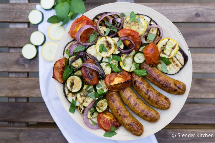 Grilled chicken sausage with vegetables on a plate.