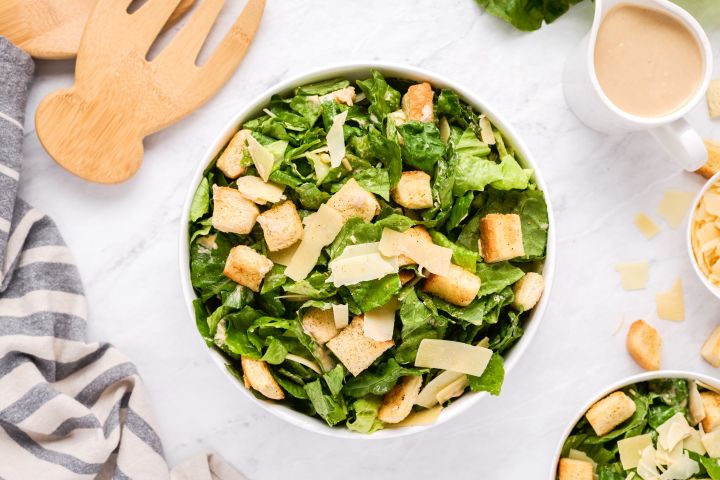 Healthy caesar salad with greens, croutons, parmesan cheese, and a lightened  up dressing.