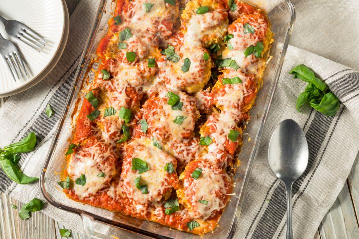 Healthy Eggplant Parmesan in a casserole dish with tomato sauce and melted cheese.