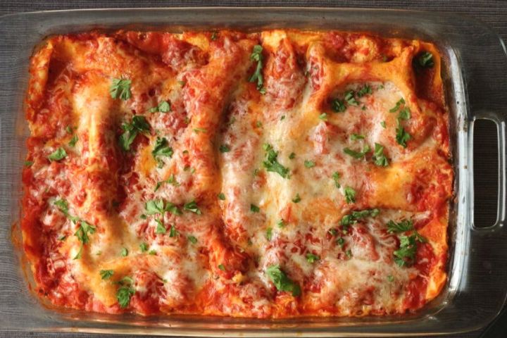 Healthy zucchini lasagna in a glass baking dish with melted cheese on top.