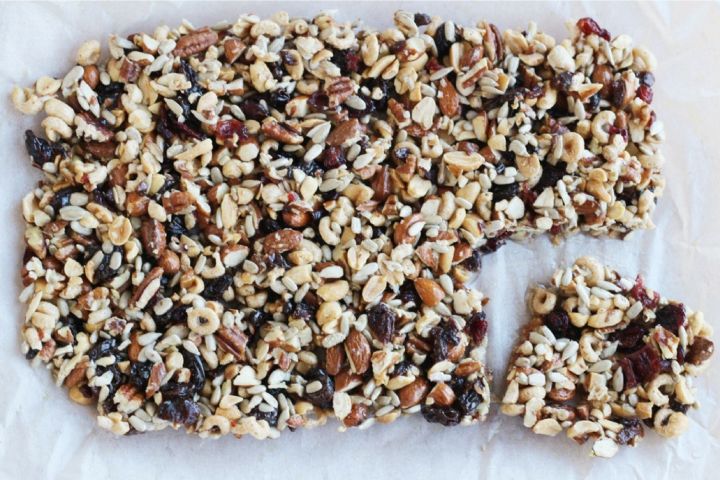 Fruit and Nut bars in a baking dish with cheerios, dried fruits, and mixed nuts.