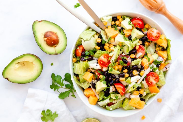 Mexican chopped salad with black beans, corn, avocado, and Mexican dressing.