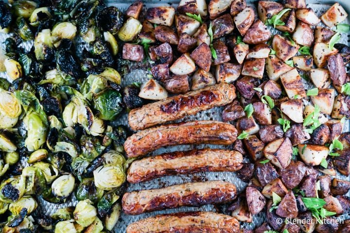 Sheet pan sausage with potatoes and Brussels sprouts on a sheet pan. 