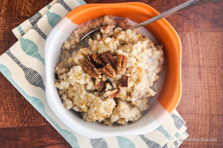 Make ahead steel cut oatmeal in a bowl with sliced bananas and nuts.