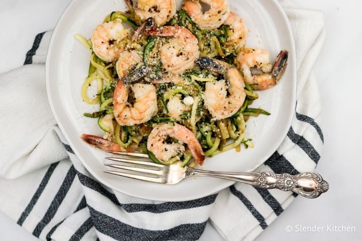 Pesto shrimp and zucchini noodles with Parmesan cheese and lemon,