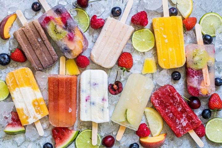 Homemade popsicles including strawberry, peaches and cream, watermelon, chocolate, and lemon lime. 