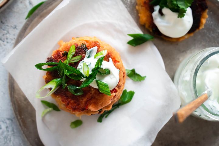 Salmon patties made with canned salmon, fresh herbs, breadcrumbs, and bell peppers cooked until golden brown.