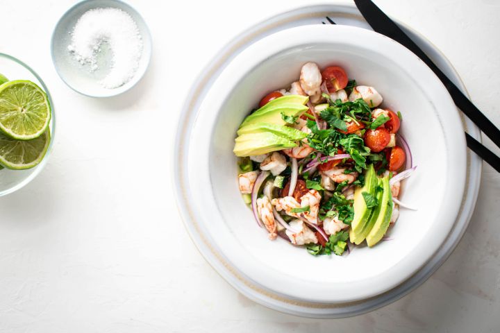 Shrimp Ceviche cured in lime juice with avocado, tomatoes, cucumbers, and red onion.