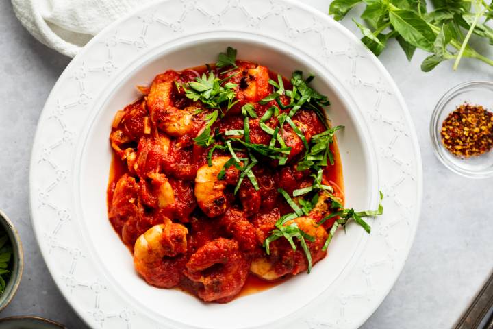 Shrimp fra diavolo with cooked shrimp in spicy tomato sauce with fresh basil.
