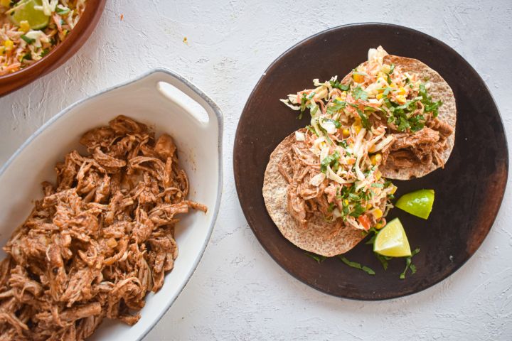 Slow Cooker Chorizo Spiced Pulled Pork in a corn tortilla with cabbage slaw.