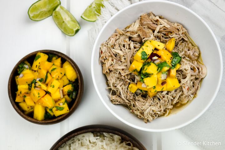 Slow cooker jerk chicken with shredded chicken served with mango salsa and cilantro.
