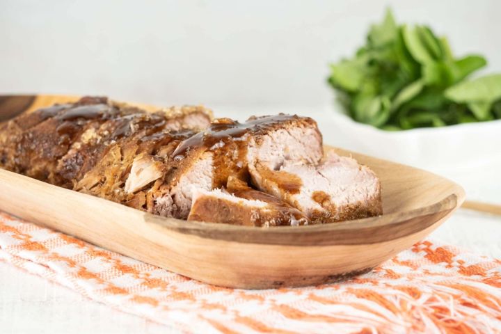 Slow Cooker Balsamic Pork cut into slices with glaze.