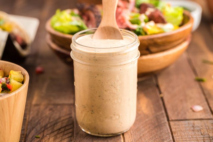 Southwest salad dressing in a glass jar with Greek yogurt, lime juice, taco seasoning, and salsa.