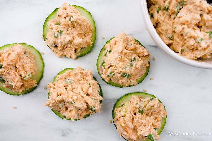 Spicy tuna salad on cucumber slices with sesame seeds.