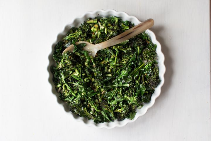 Asian broccolini chopped and cooked with garlic, ginger, and oyster sauce in a dish.