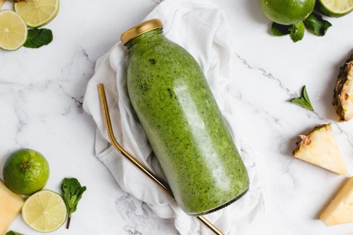 Tropical Mojito Pineapple Smoothie with mint and lime juice in a glass jar.