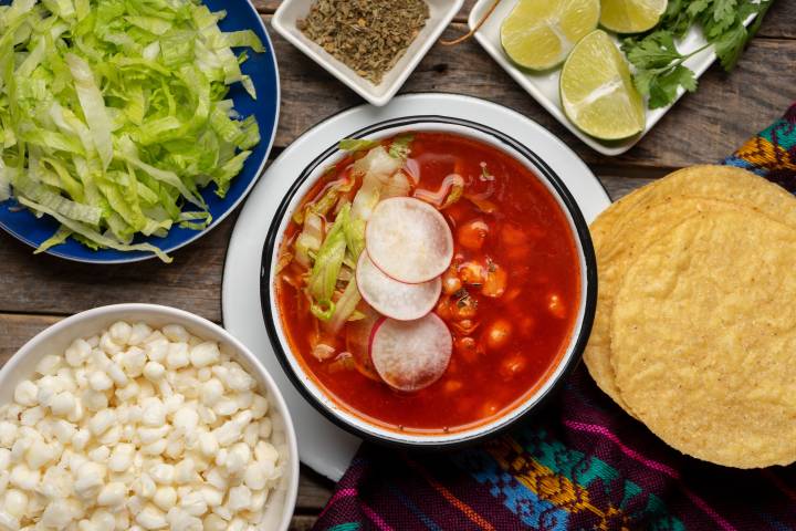 Vegetarian pozole with hominy, beans, radishes, avocado, and a rich dried red chile broth.