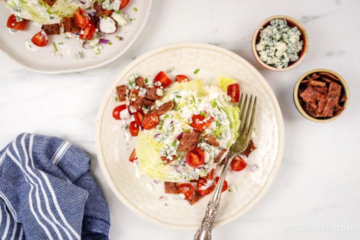 Classic wedge salad with creamy blue cheese dressing, tomatoes, red onions, and crispy bacon.