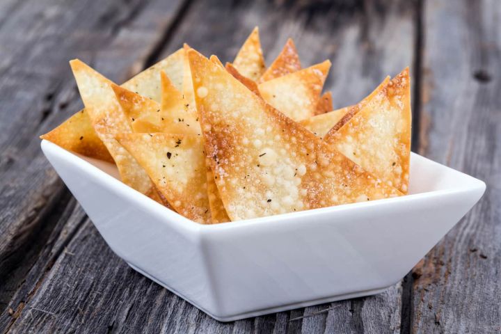 Crispy Wonton chips in a bowl with salt and pepper.