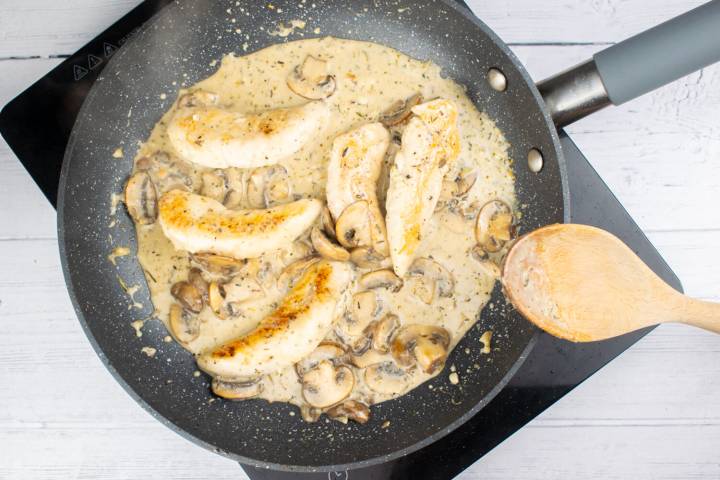 Mushroom chicken in a skillet with a creamy garlic sauce.