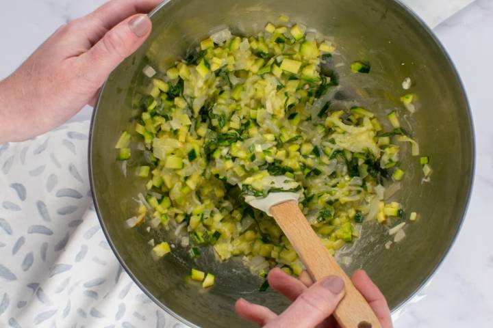 Zucchini, onions, mozzarella, and ricotta cheese in a bowl.