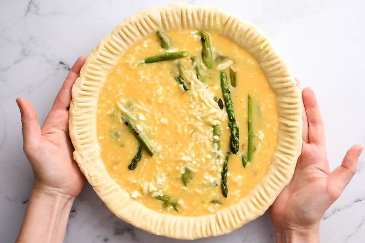 Egg custard poured over asparagus spears in a pie crust.