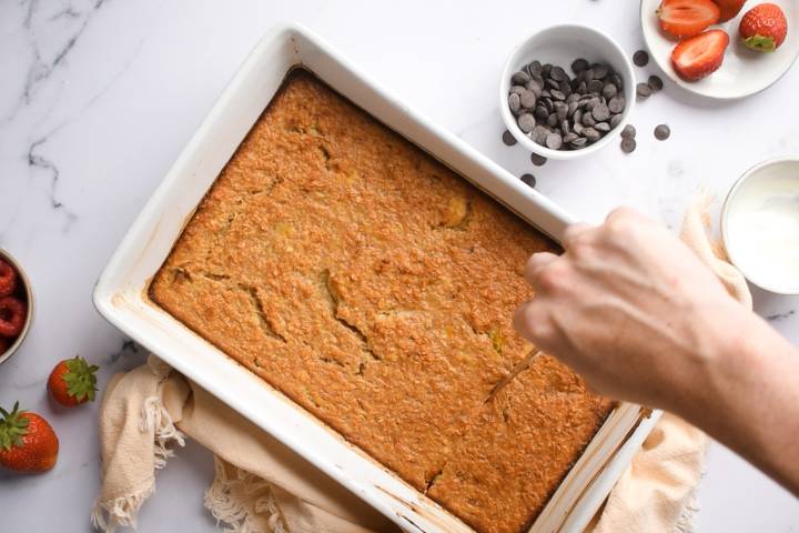 Baked oatmeal being cut into slices. 