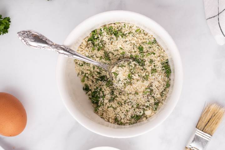 Breadcrumbs, Parmesan cheese, parsley, Italian seasoning, garlic, and pepper in a small bowl.