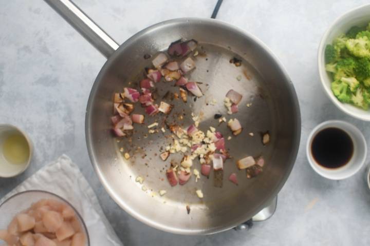 Red onion, garlic, and red pepper flakes in a hot skillet.