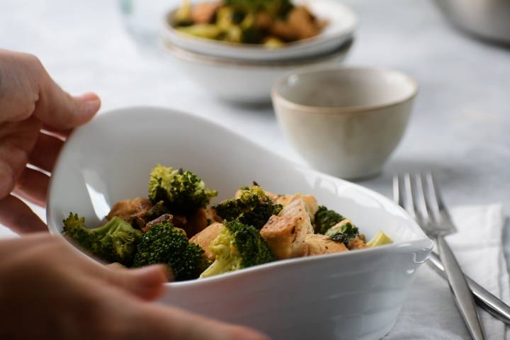 Basil chicken in a bowl with broccoli.