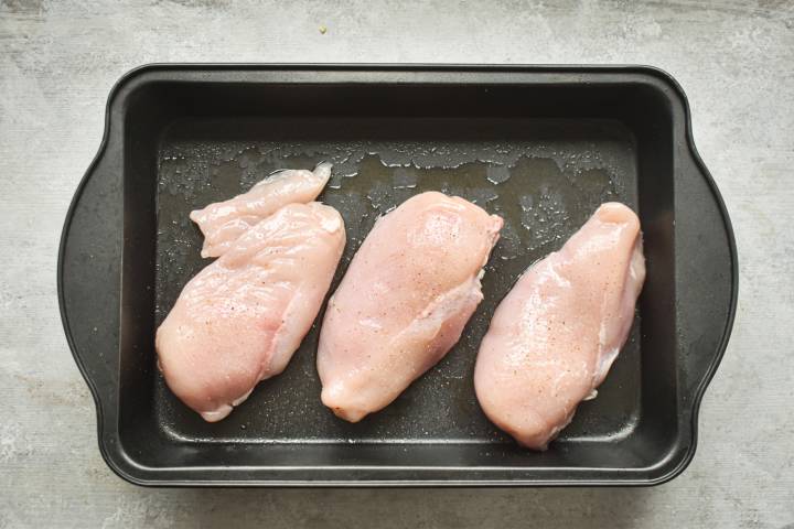 Chicken breasts in a baking dish.