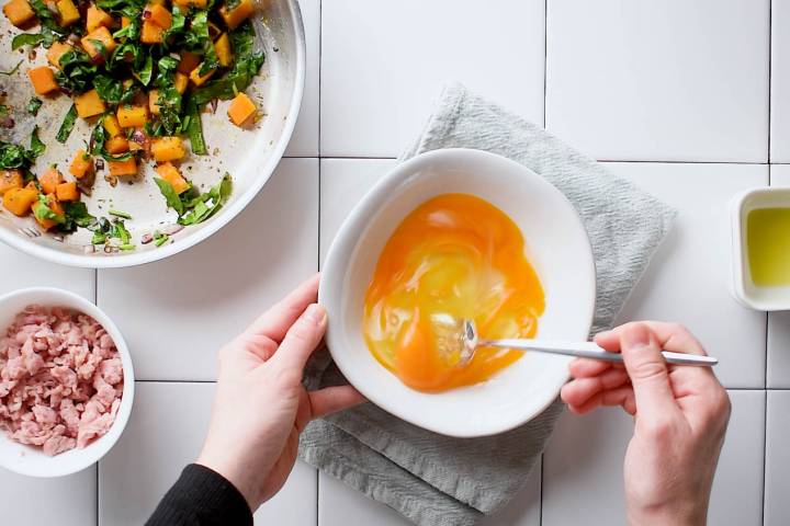 Eggs being whisked in a bowl.